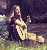 Connie Champagne, age 12, playing guitar